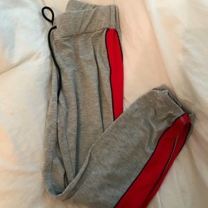 grey joggers with red strip